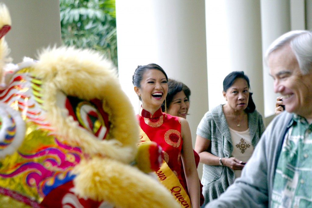 2015 Narcissus Queen and University of Hawai'i civil engineering student—Erica Wong—enjoys UH Mānoa Chancellor Robert Veley-Roman’s attempt at a tribute during a traditional Chinese Lion Dance at Hawai'i Hall, marking the arrival of the Chinese New Year at UH Mānoa.