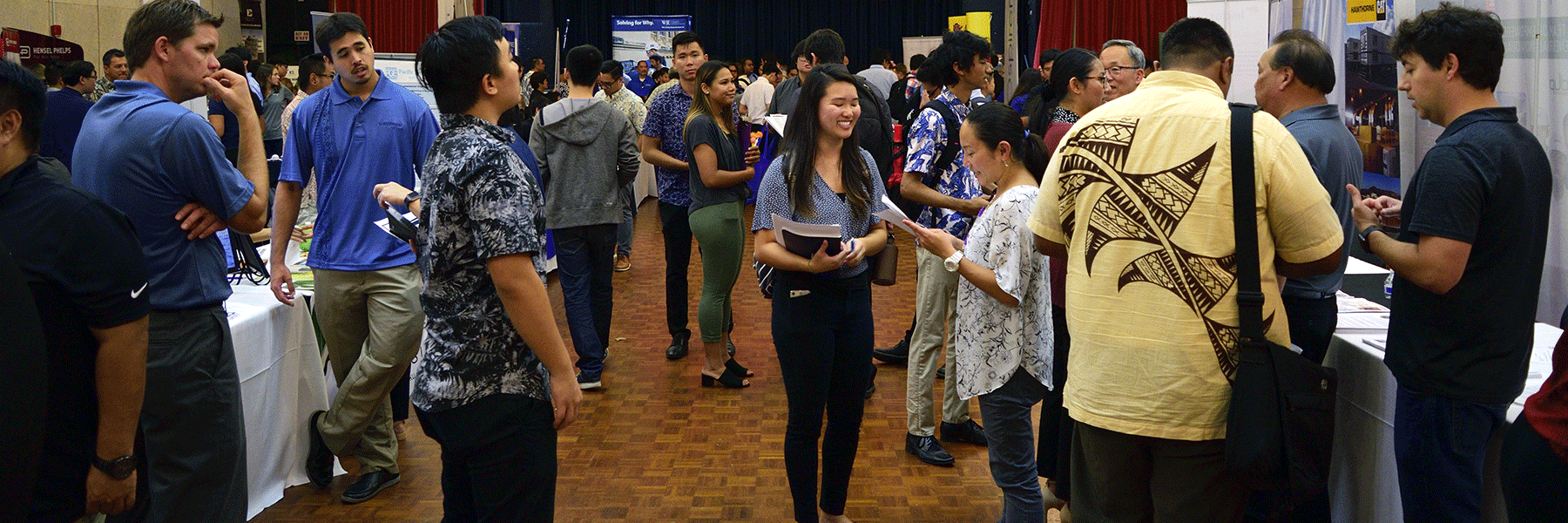 Wide Shot Of A Crowd Of Students And Recruiters Interacting.