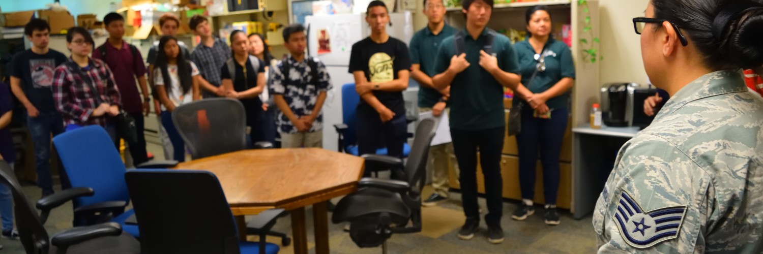 A U.S. Airwoman Briefing A Group Of Students