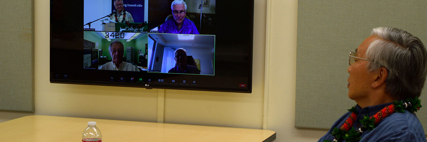 Professor Watching A Zoom Meeting