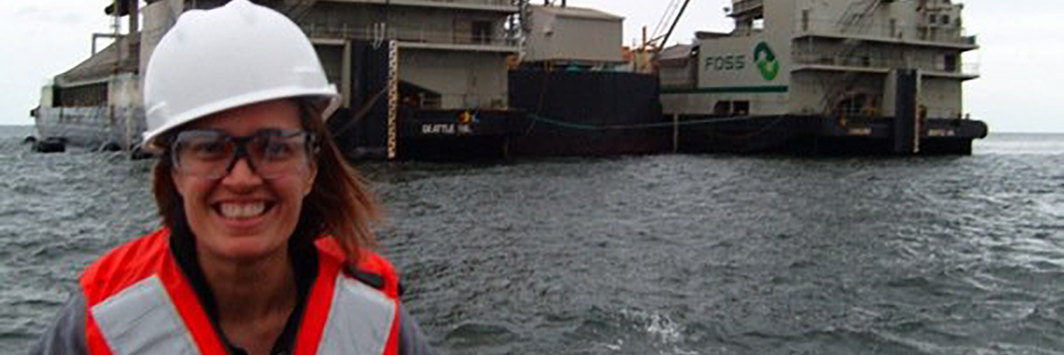 Professor In A Boat With Ocean Station In Background