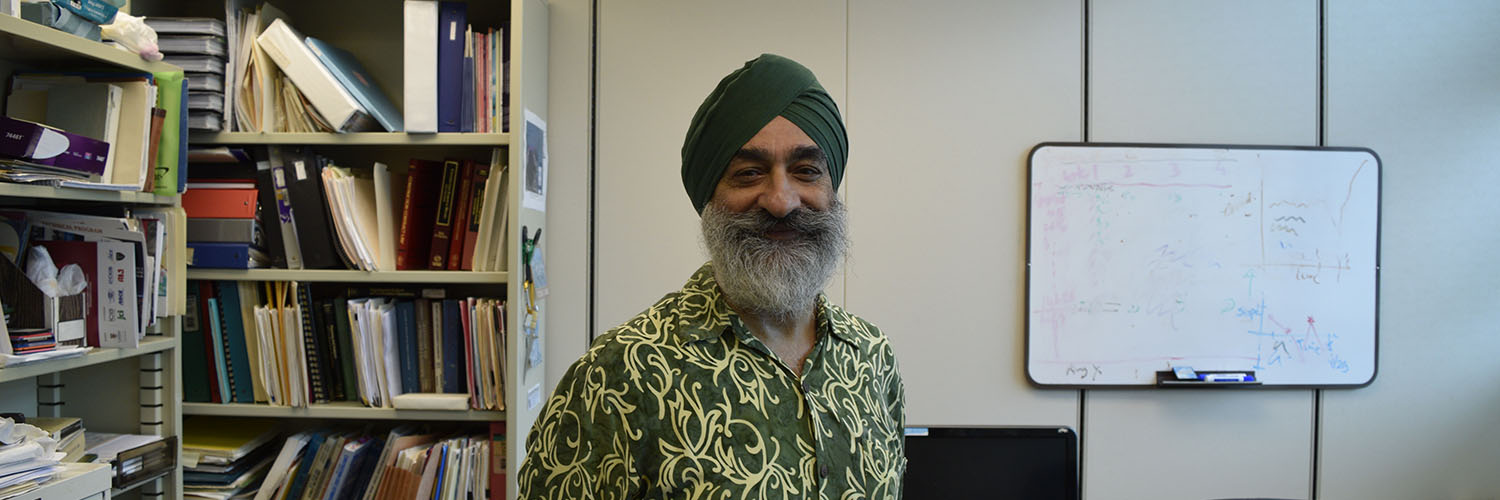 Prof. Singh Standing In His Office