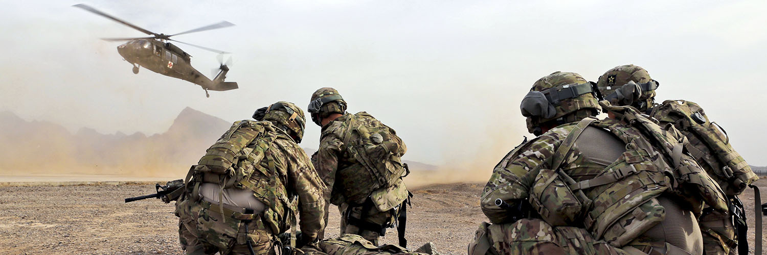 Soldiers Waiting For A Helicopter To Land