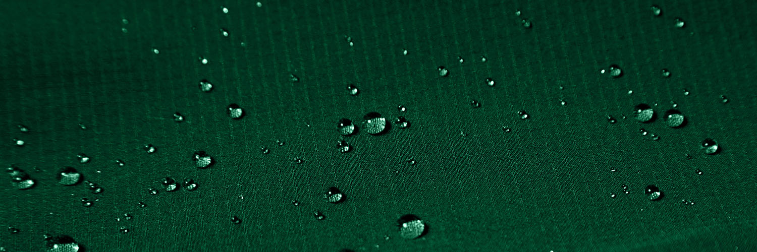 Water Beads On A Green Fabric