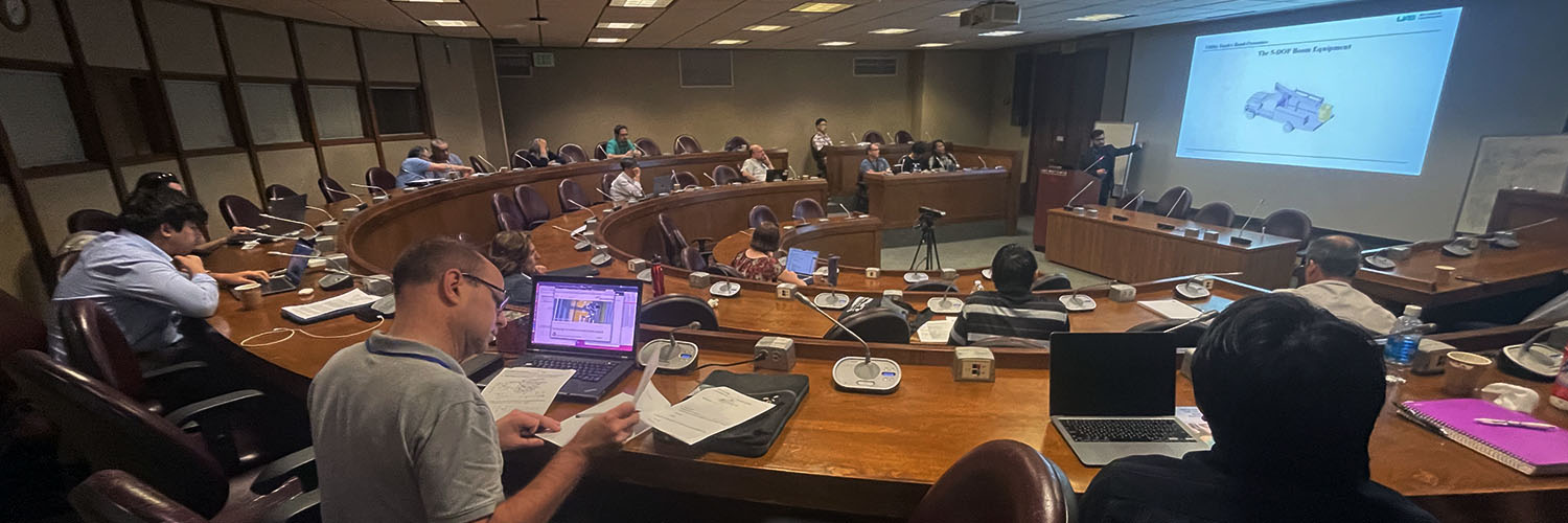 Photo Of People Listening To A Lecture In A Large Room