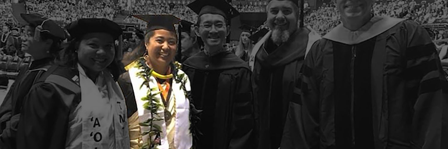 Graduates Standing Together And Posing For Photo At Commencement Ceremony