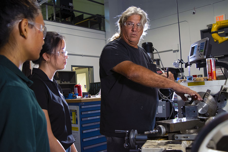 Technician advising engineering students