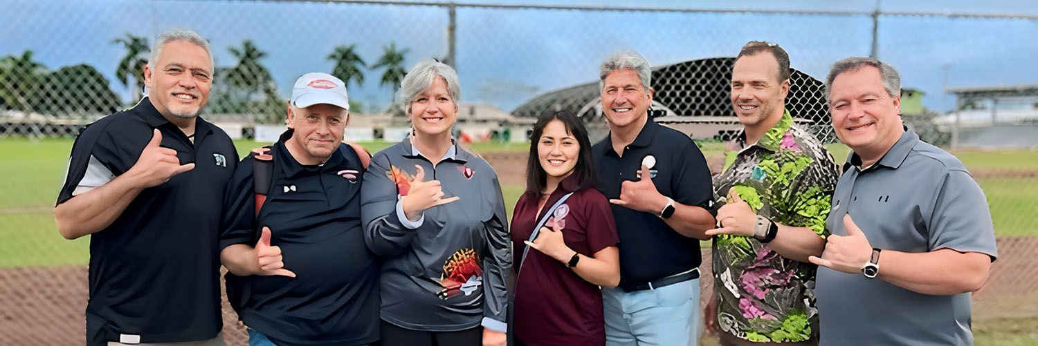 A Group Of People Posing For A Photo At A Baseball Game