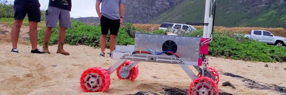 Students Monitoring A Robotic Rover Operating On A Beach