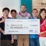 Group of people holding a big check