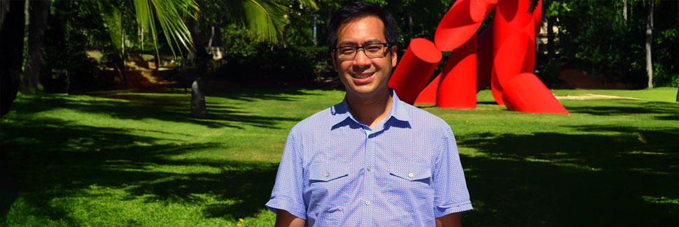 Professor Chen posing for camera on Holmes Hall lawn